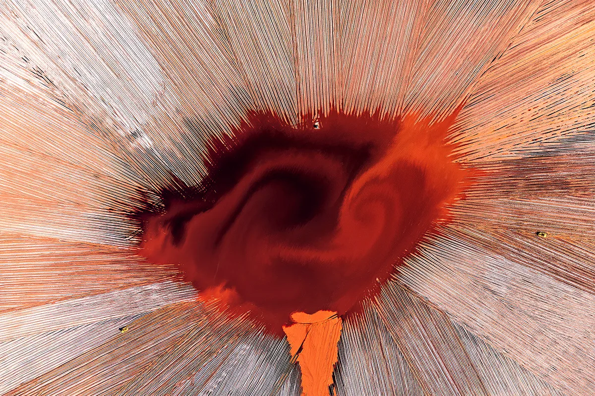 Red mass in centre of sand.