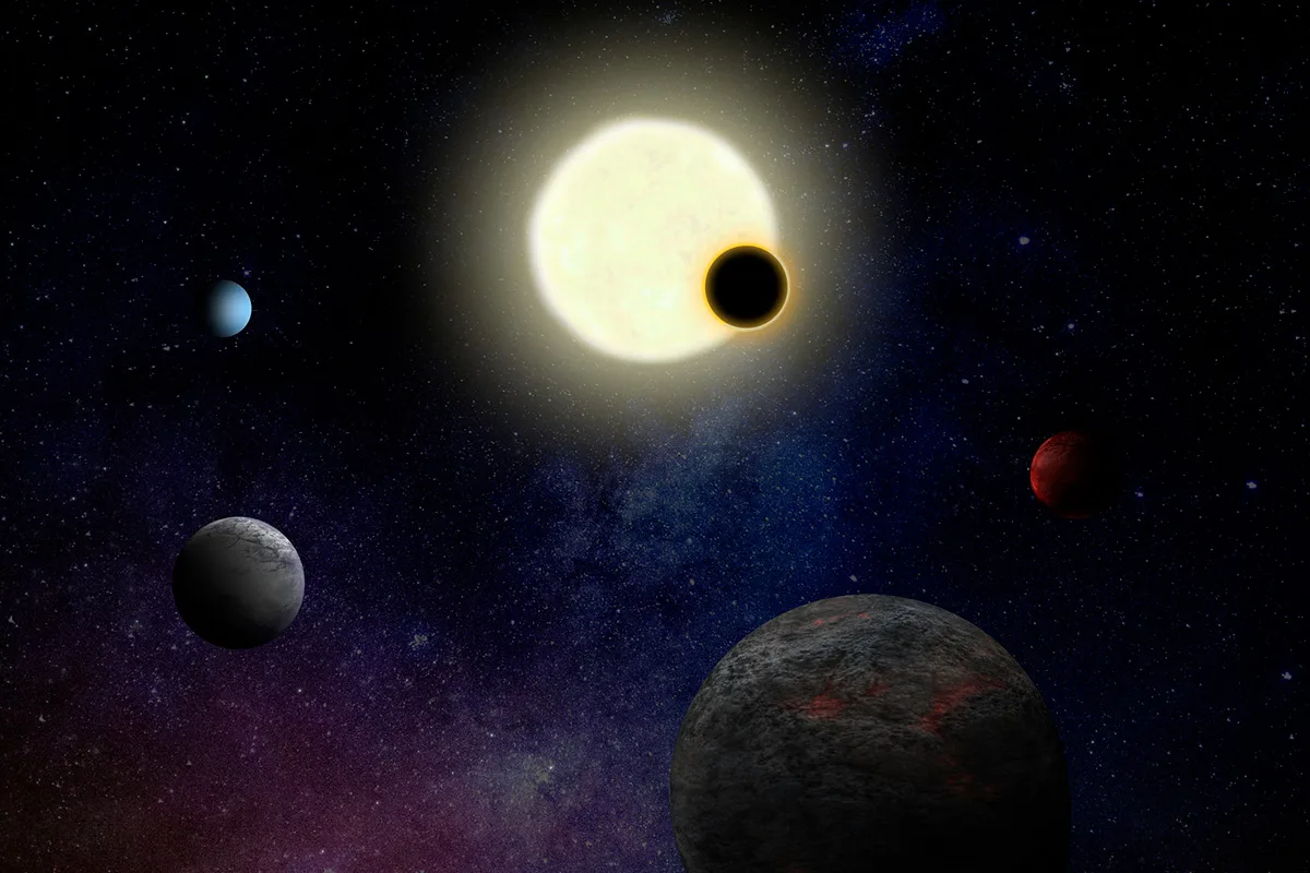 Star surrounded by planets. One planet is in front of the star.