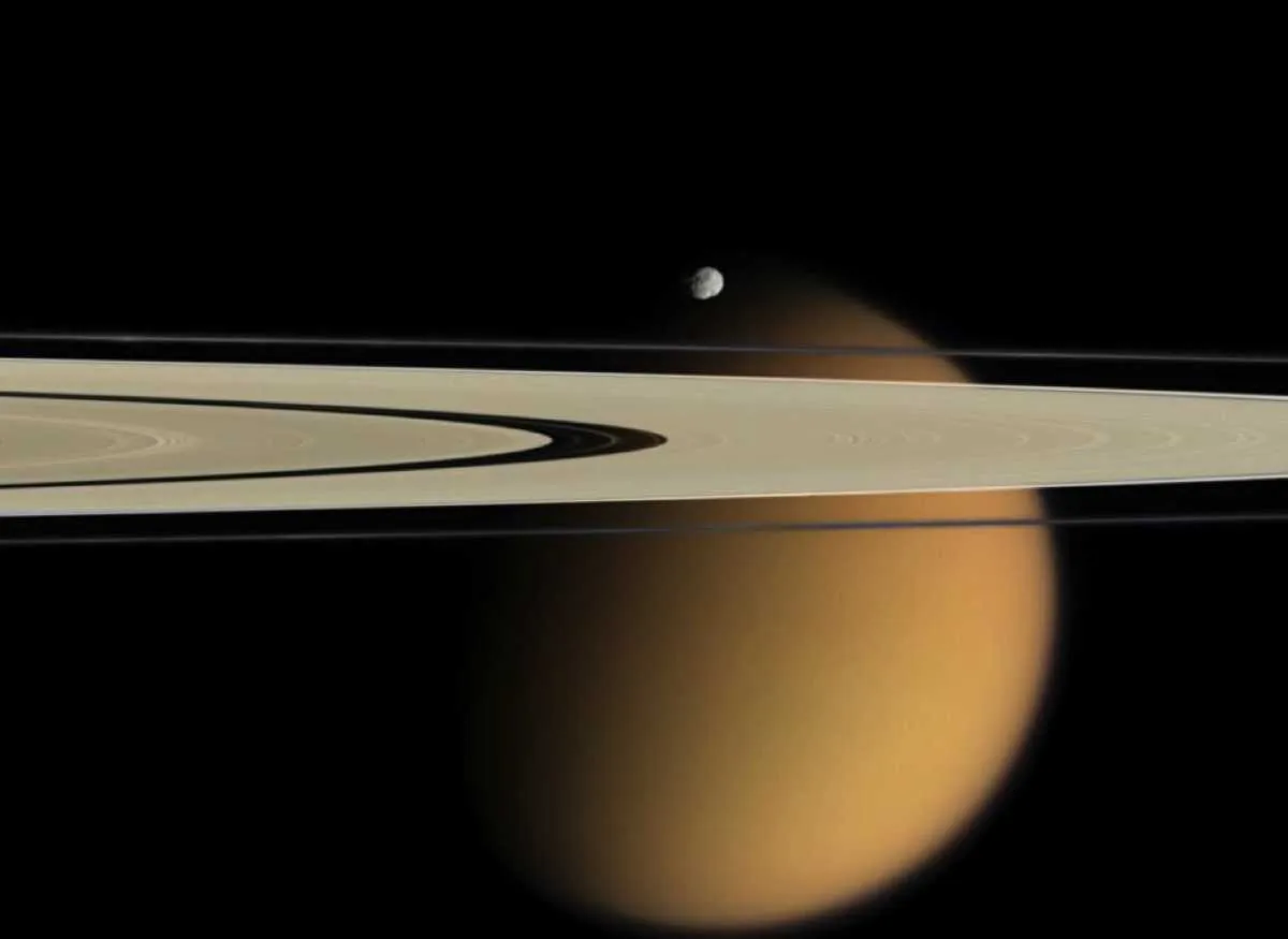 Saturn moon Epimethus with Titan in the background © NASA