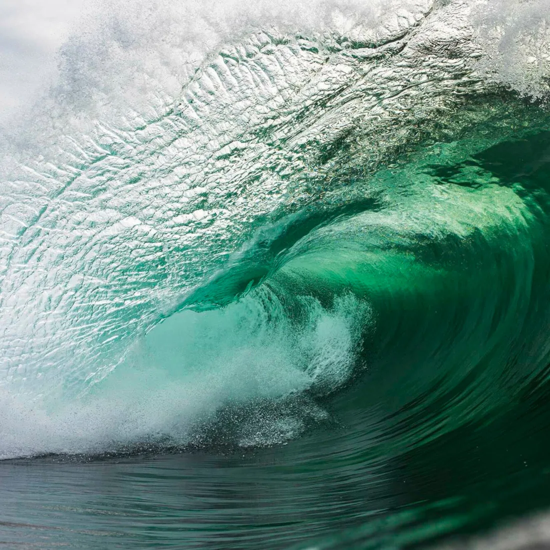 Photo of a tubular wave, green in hue rather than blue